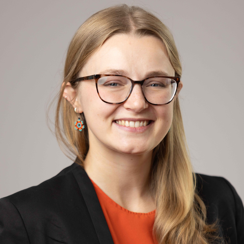 photo of a woman smiling, wearing glasses